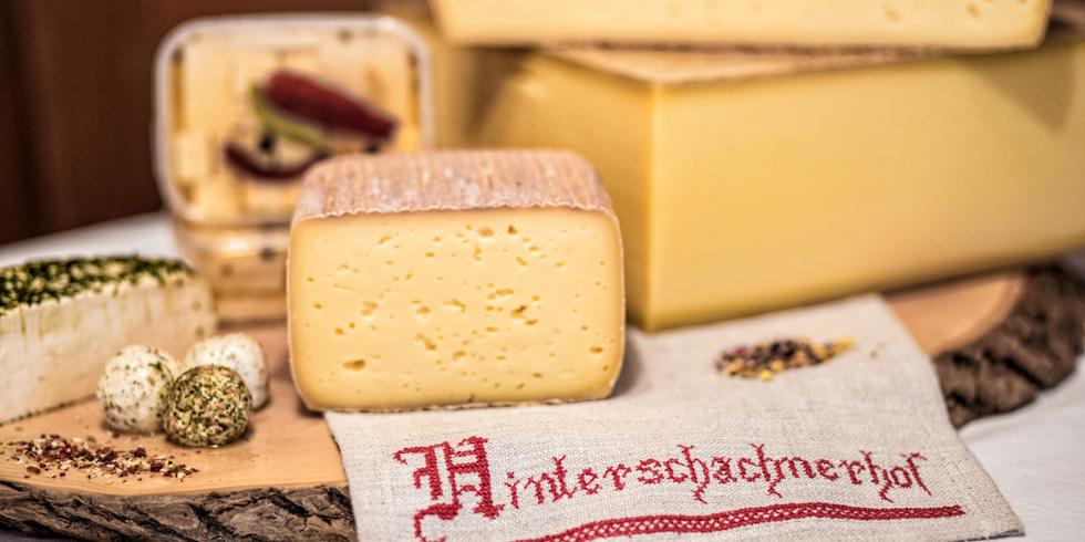 Hausgemachter Käse vom Hinterschachnerhof, daneben das bestickte Hoftuch